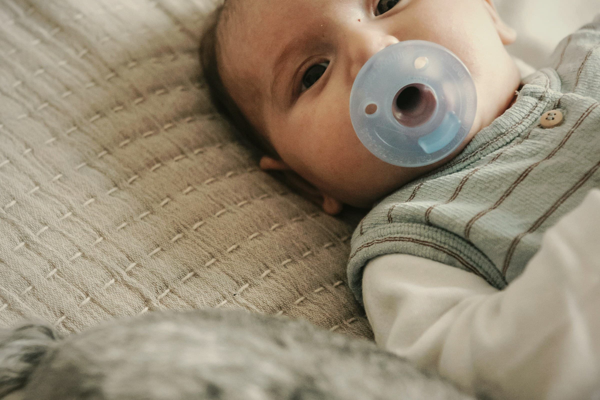 A calm baby moment in soft warm light.