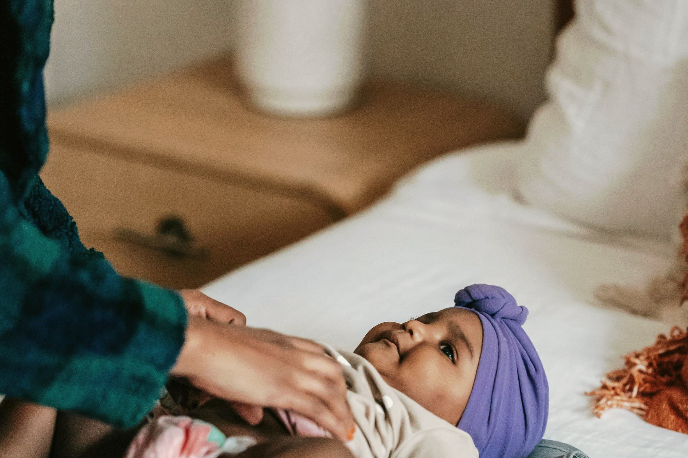 A tender parenting moment in warm natural light.